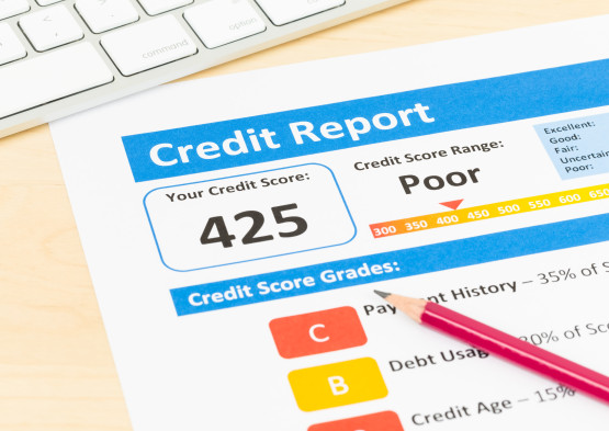 Poor credit score report with pen and keyboard